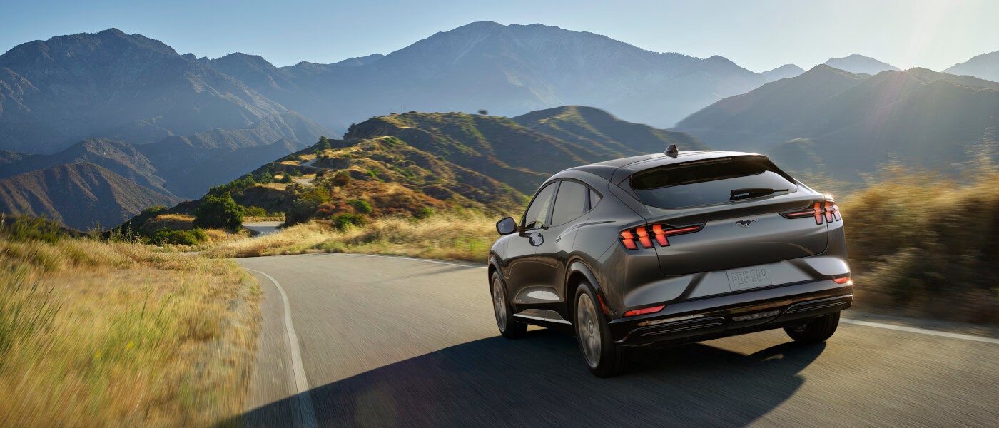 2025 Ford Mustang Mach-E Exterior Driving In Grassy Mountains