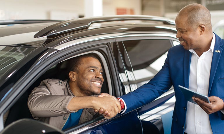 Couple making deal at dealership